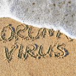 Coronavirus concept. “Stop Coronavirus” written on sand.